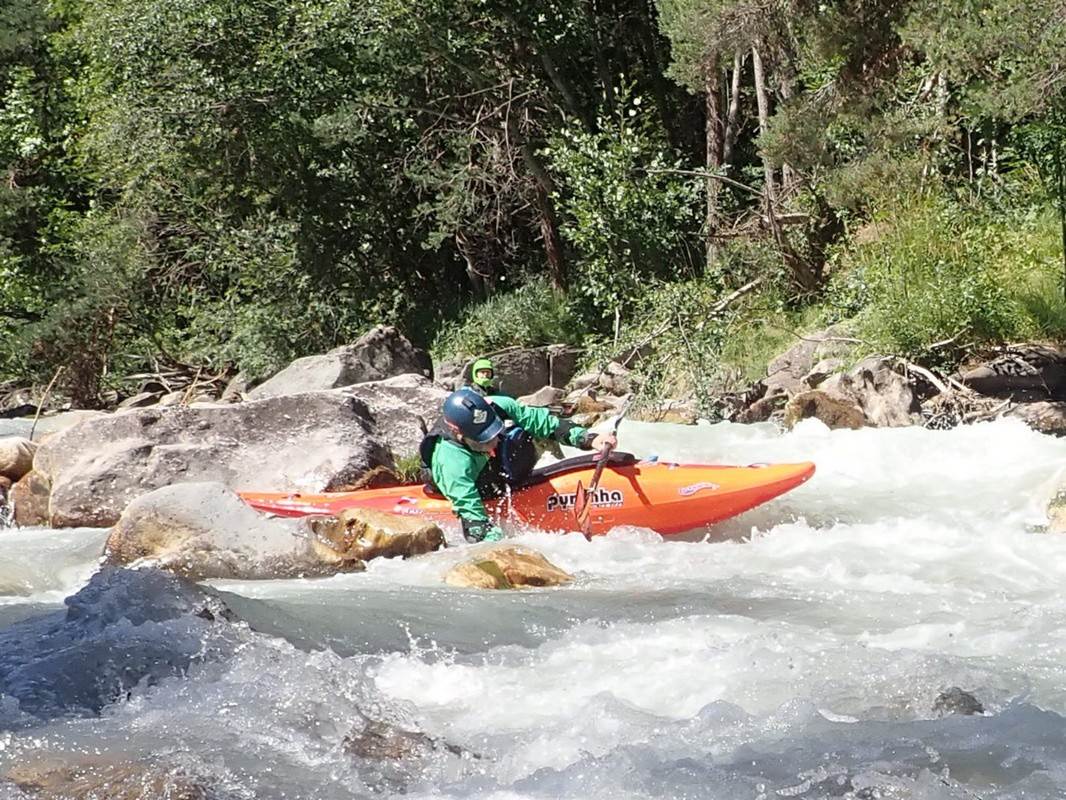 A person in a kayak in a river

Description automatically generated with medium confidence