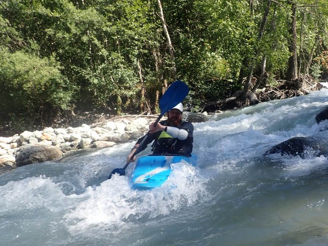 A person in a kayak in a river

Description automatically generated with low confidence