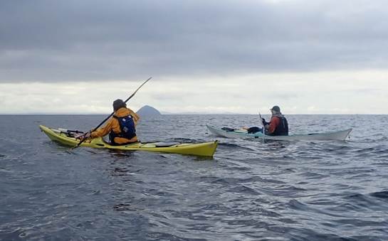 A couple of people in kayaks on a body of water

Description automatically generated with low confidence