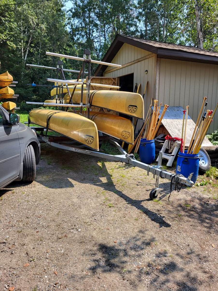 A boat trailer with canoes and other equipment

Description automatically generated with medium confidence