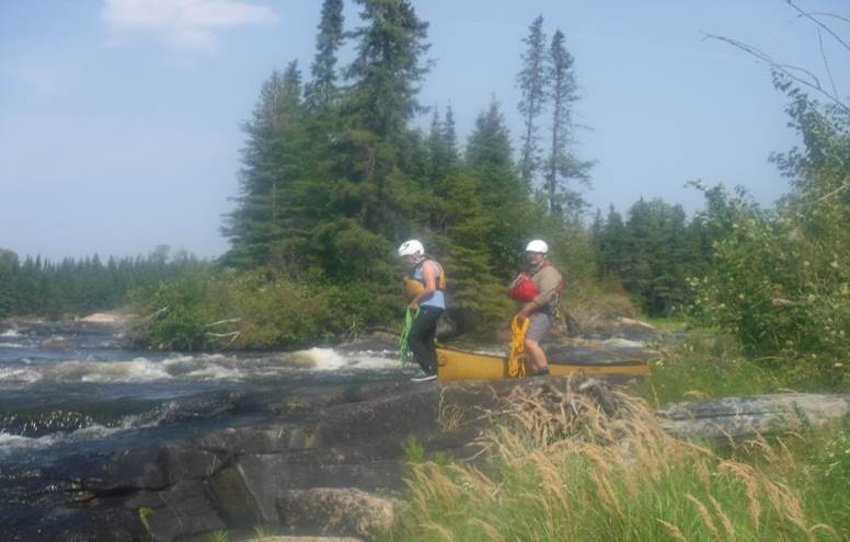 A couple of people in a canoe

Description automatically generated