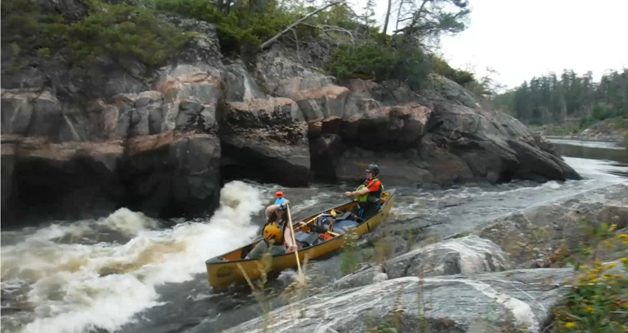 A couple of people in a canoe

Description automatically generated