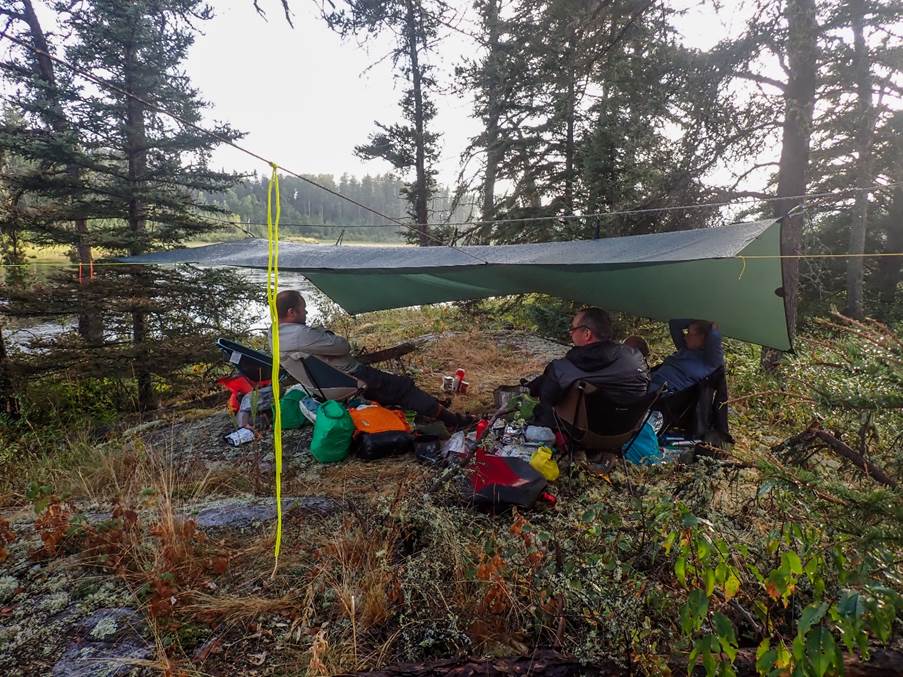 A group of people sitting under a tent

Description automatically generated