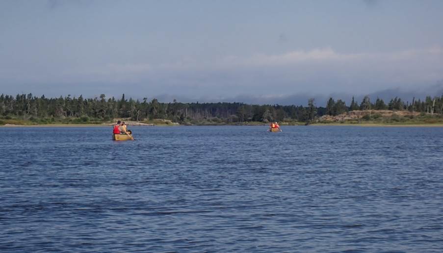 Several people in canoes in a lake

Description automatically generated