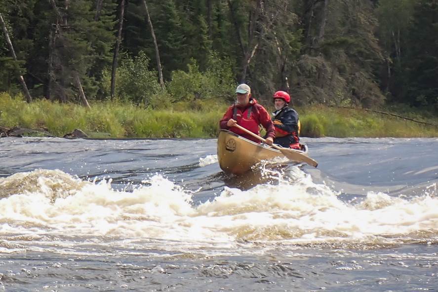 A couple of people in a canoe

Description automatically generated