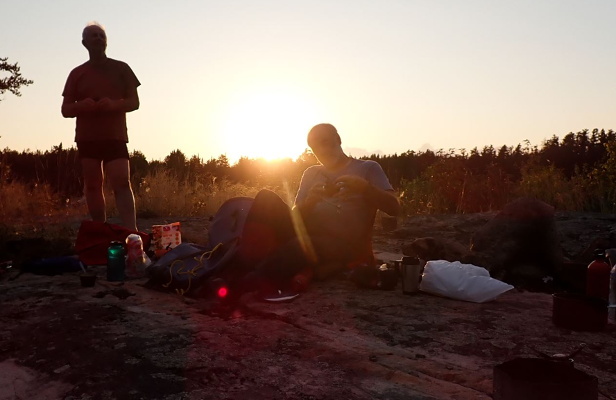 A group of people sitting on a rock

Description automatically generated