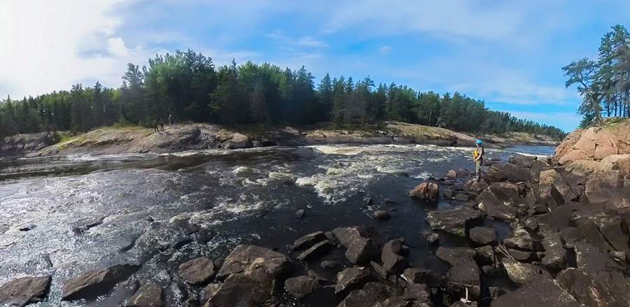 A river with rocks and trees

Description automatically generated