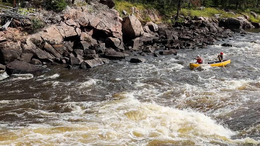 A person in a kayak on a river

Description automatically generated