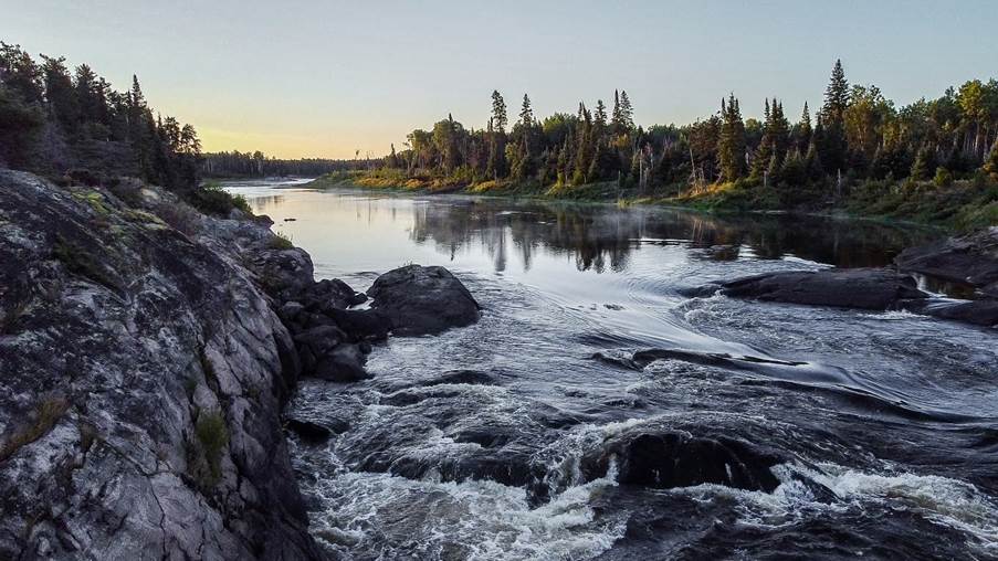 A river with rocks and trees

Description automatically generated