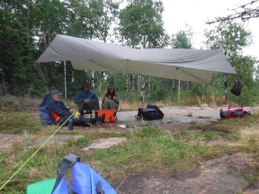 A group of people sitting under a canopy

Description automatically generated