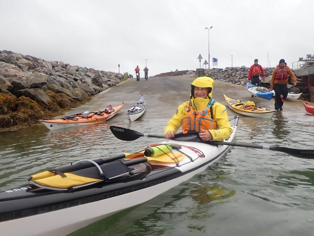 A group of people in kayaks on a dock

Description automatically generated