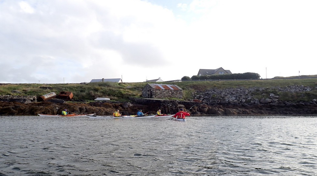 A group of people kayaking on a lake

Description automatically generated