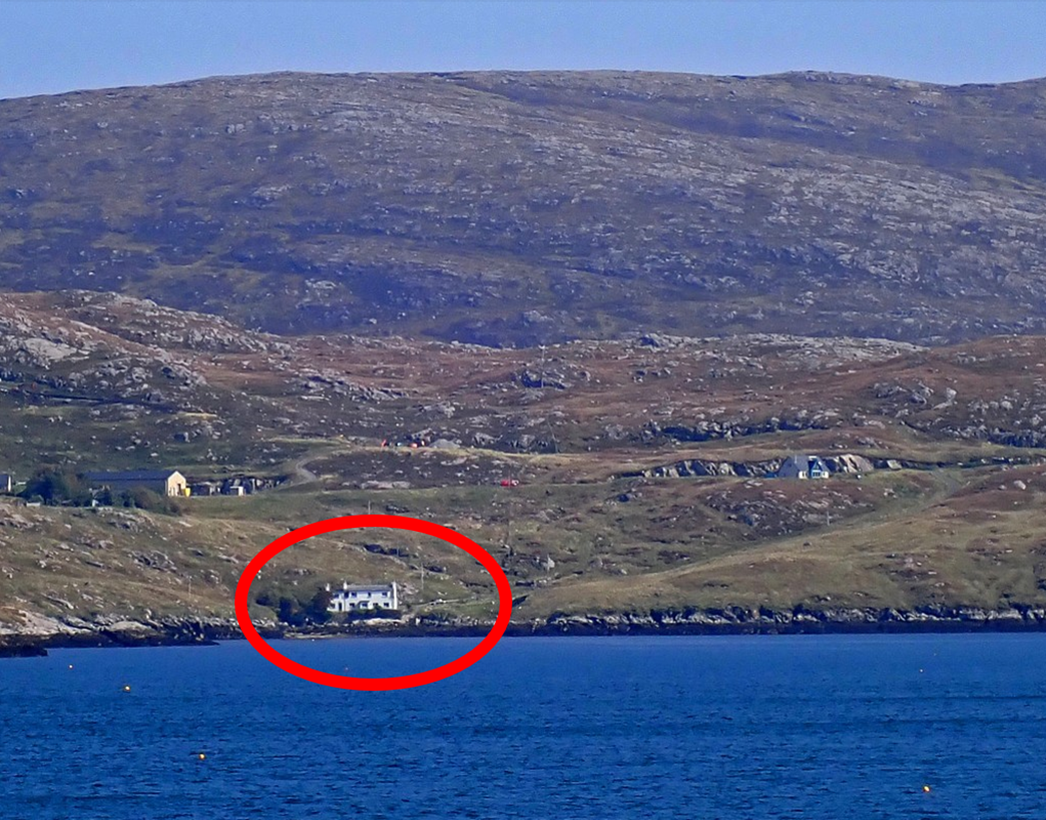 A house on a hill by water

Description automatically generated
