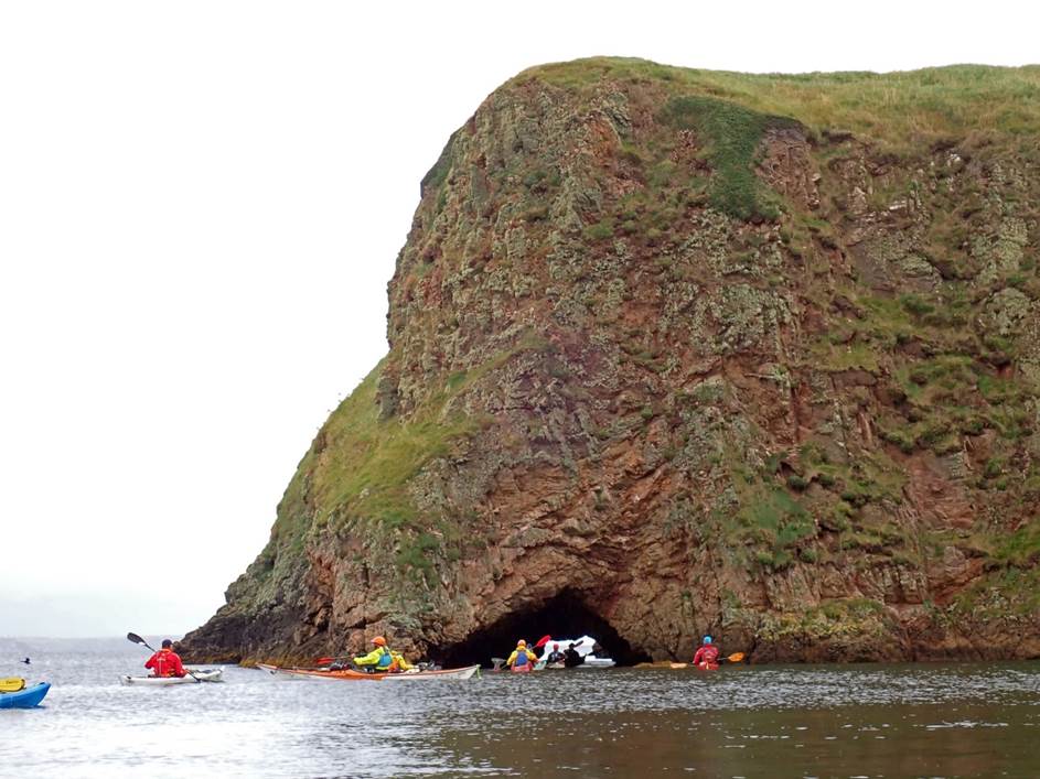 A group of people kayaking in the water

Description automatically generated