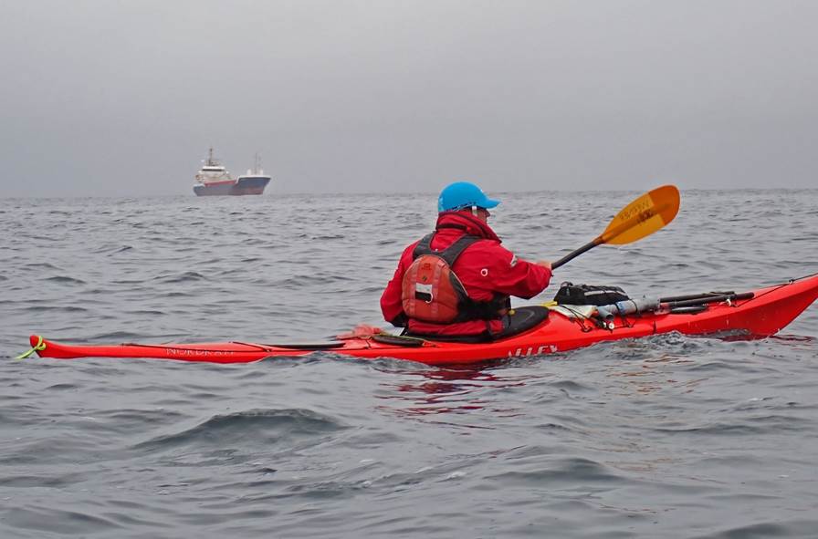 A person in a kayak on the water

Description automatically generated