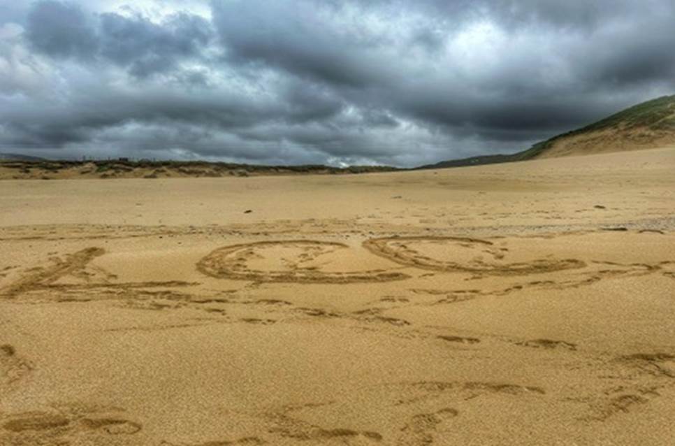 A sand dunes with a cloudy sky

Description automatically generated with medium confidence