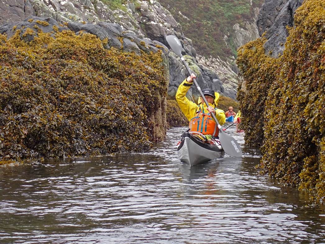 A person in a canoe in a river

Description automatically generated