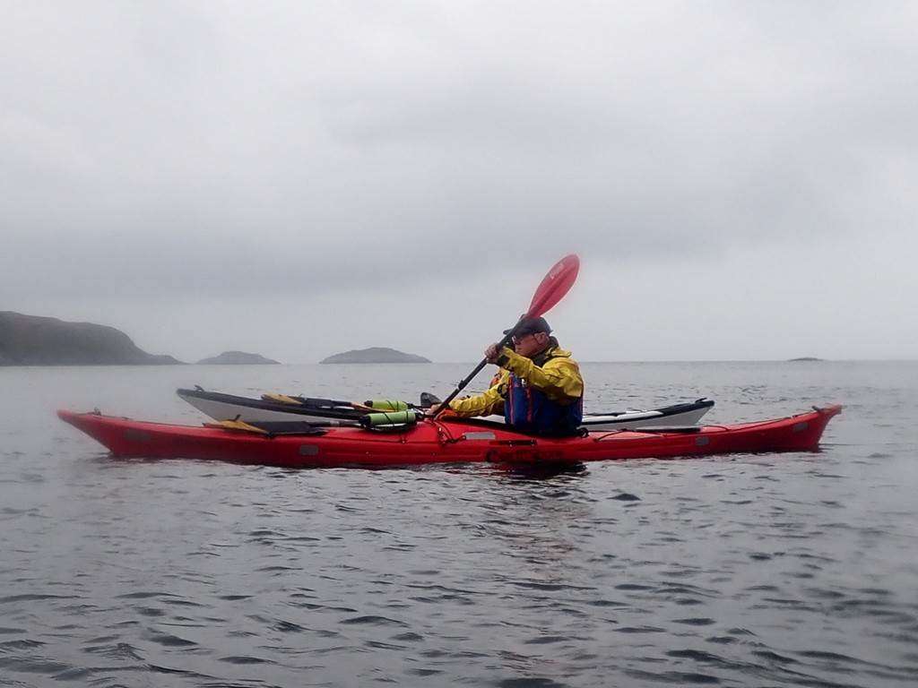 A person in a kayak on the water

Description automatically generated