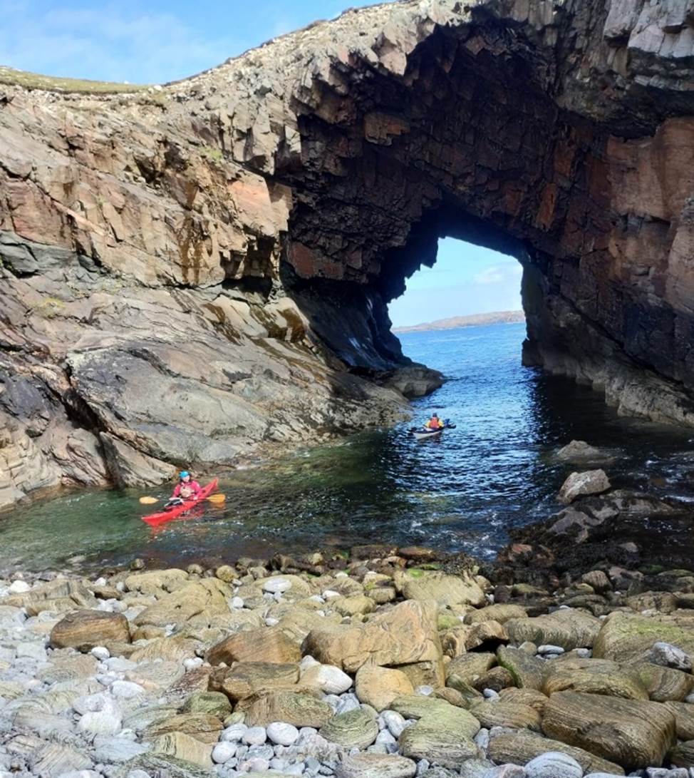 A cave with a hole in the water

Description automatically generated