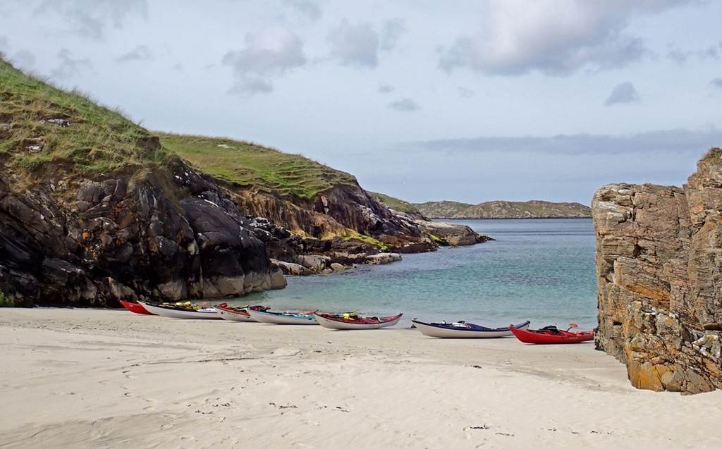 A row of boats on a beach

Description automatically generated
