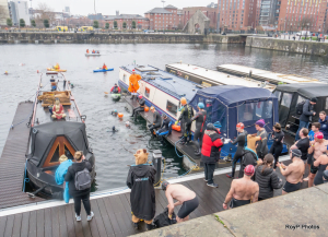 A group of people on a boat Description automatically generated with low confidence