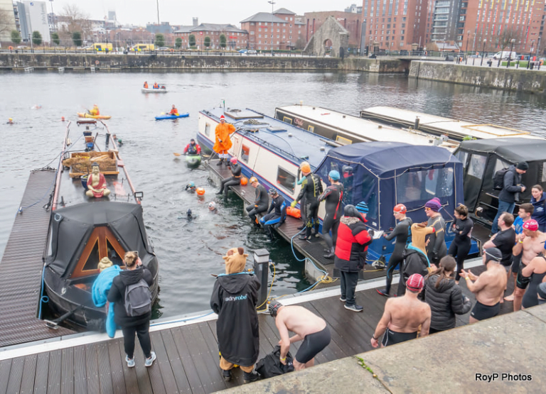 A group of people on a boat Description automatically generated with low confidence