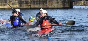 A group of people in a boat Description automatically generated with low confidence