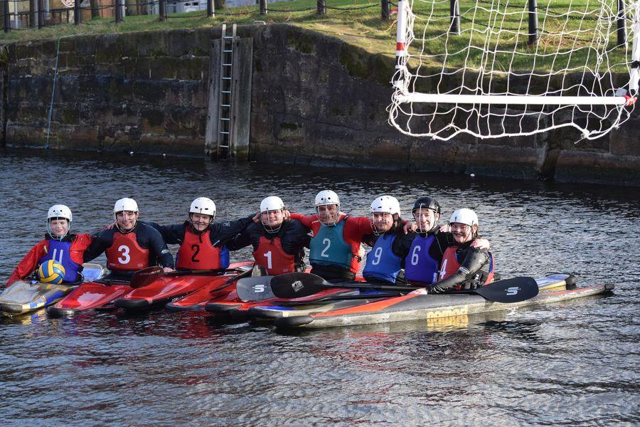 A group of people in a row boatDescription automatically generated with low confidence