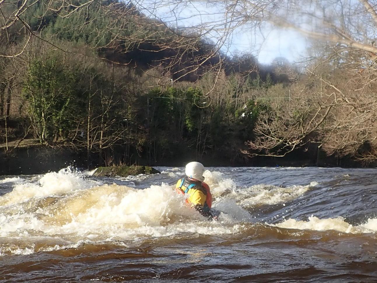 A person in a kayak in a riverDescription automatically generated with low confidence