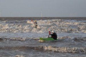 A picture containing outdoor, water, sky, surfing Description automatically generated