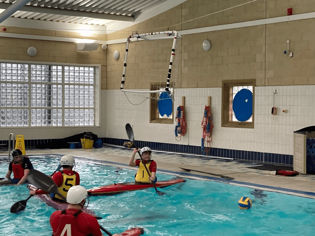 A group of people in a swimming poolDescription automatically generated with medium confidence