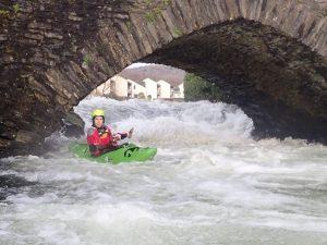 A person kayaking in a river Description automatically generated with low confidence