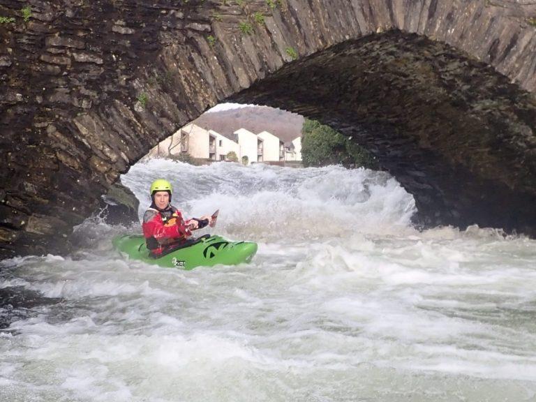 A person kayaking in a river Description automatically generated with low confidence