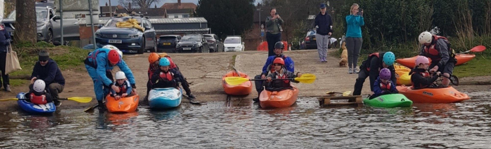 A group of people in inner tubesDescription automatically generated with medium confidence