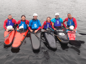 A group of people in a boat Description automatically generated with low confidence