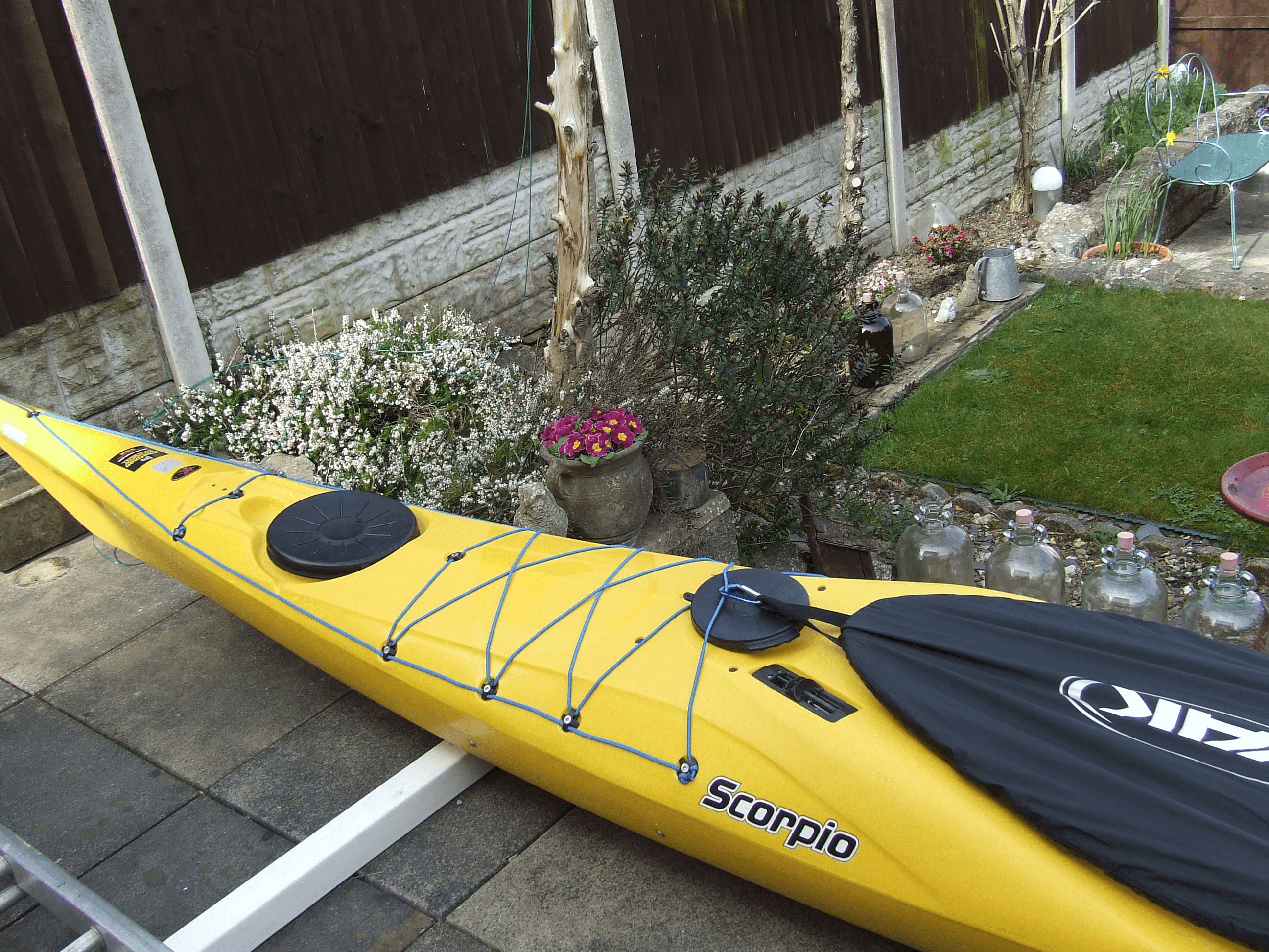A yellow kayak on a deckDescription automatically generated with low confidence