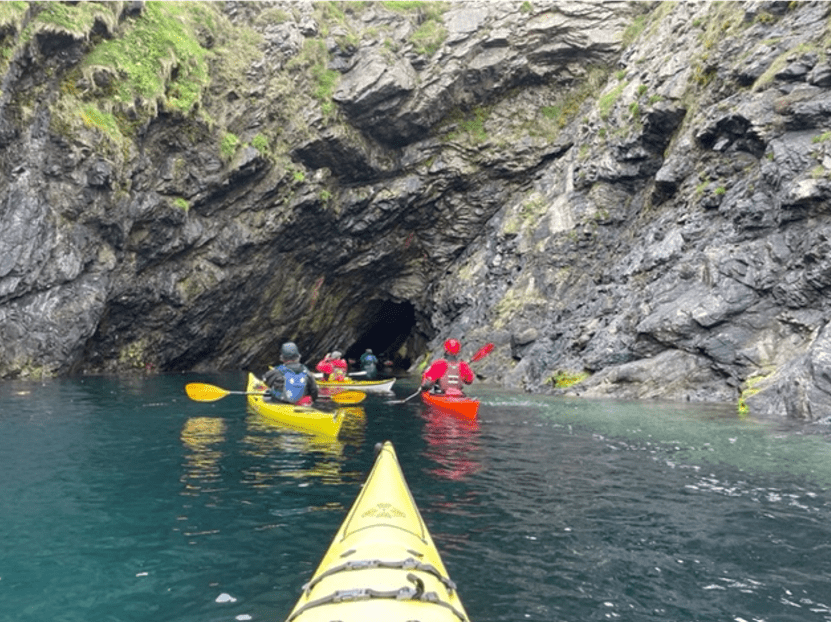 A group of people in kayaks in a riverDescription automatically generated with low confidence