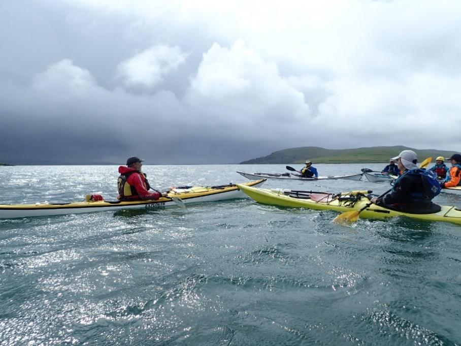 A group of people rowing a boat

Description automatically generated with medium confidence
