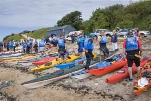 A picture containing outdoor, ground, group, boat Description automatically generated