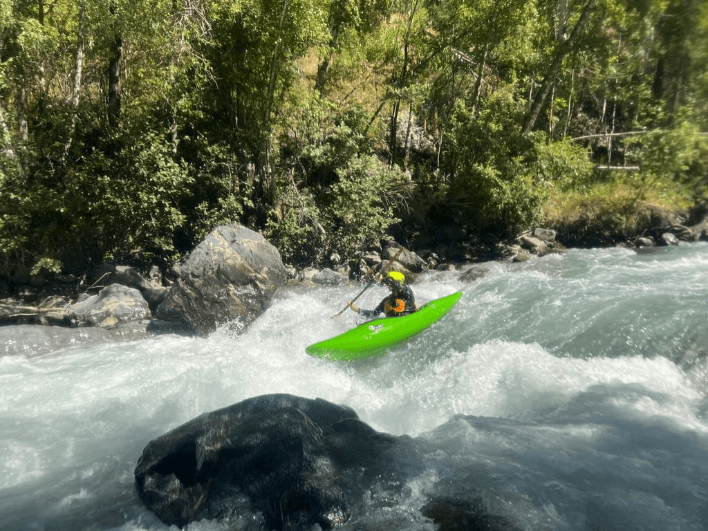 A group of people kayaking in a riverDescription automatically generated with low confidence