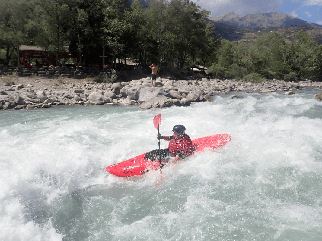 A person in a kayak in a riverDescription automatically generated with low confidence