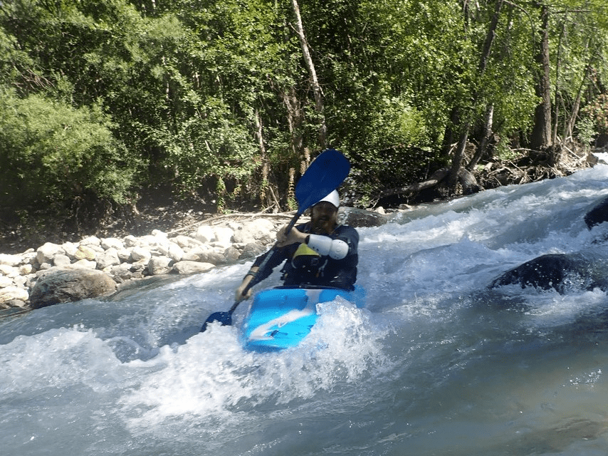 A person in a kayak in a riverDescription automatically generated with low confidence