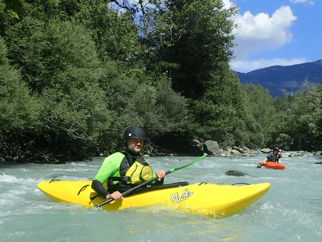A person in a kayak in a riverDescription automatically generated with low confidence