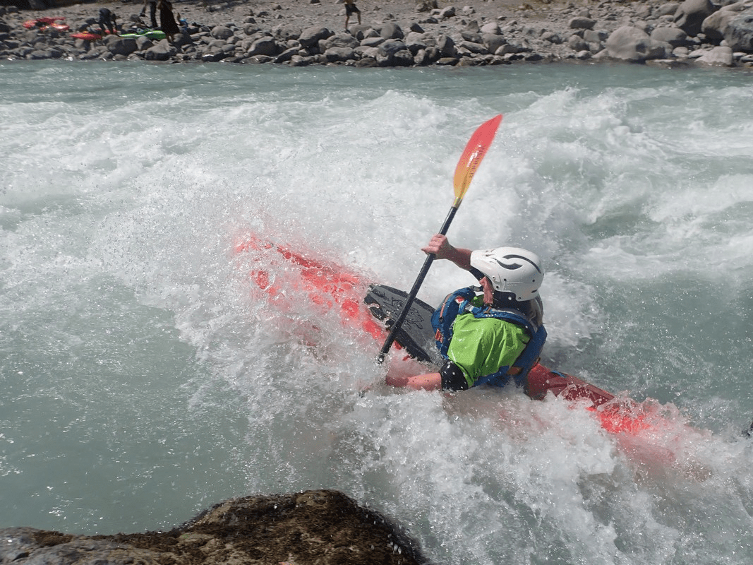 A person kayaking in a riverDescription automatically generated with medium confidence