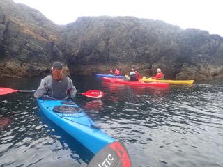 A group of people in kayaks on a riverDescription automatically generated with low confidence