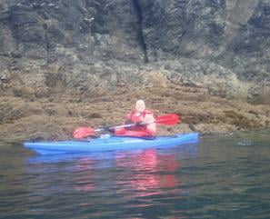 A person in a kayak on a riverDescription automatically generated with medium confidence