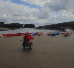 A person riding a motorcycle on a beachDescription automatically generated with low confidence