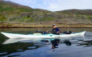 A picture containing mountain, water, outdoor, boat Description automatically generated