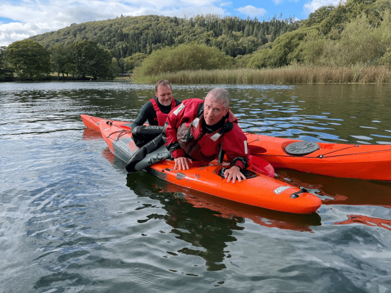 A picture containing water, outdoor, orange, riding Description automatically generated