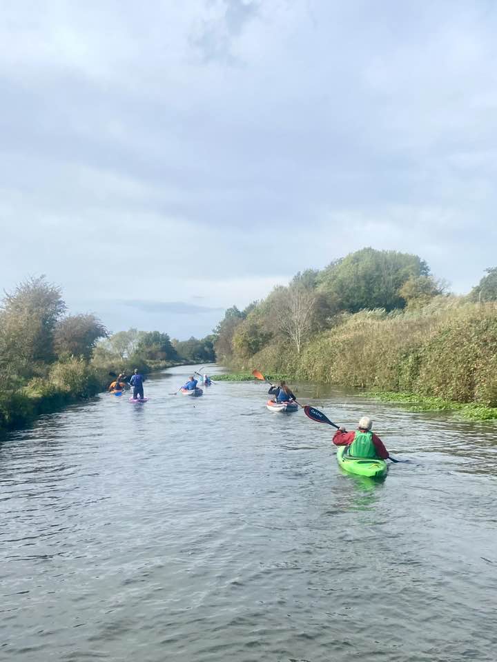 A group of people in a riverDescription automatically generated with low confidence